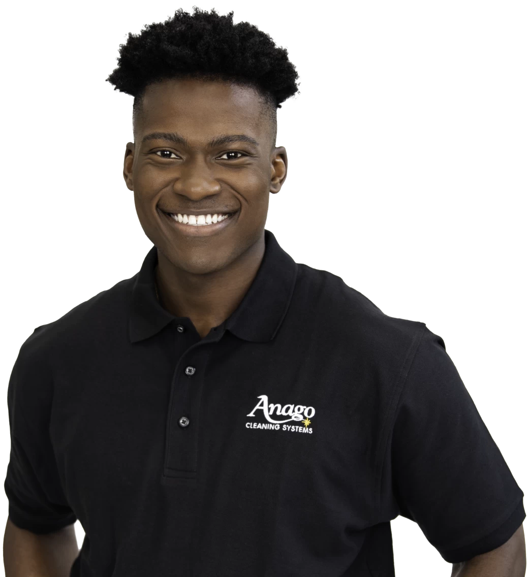 Smiling Anago unit franchisee in a branded polo shirt