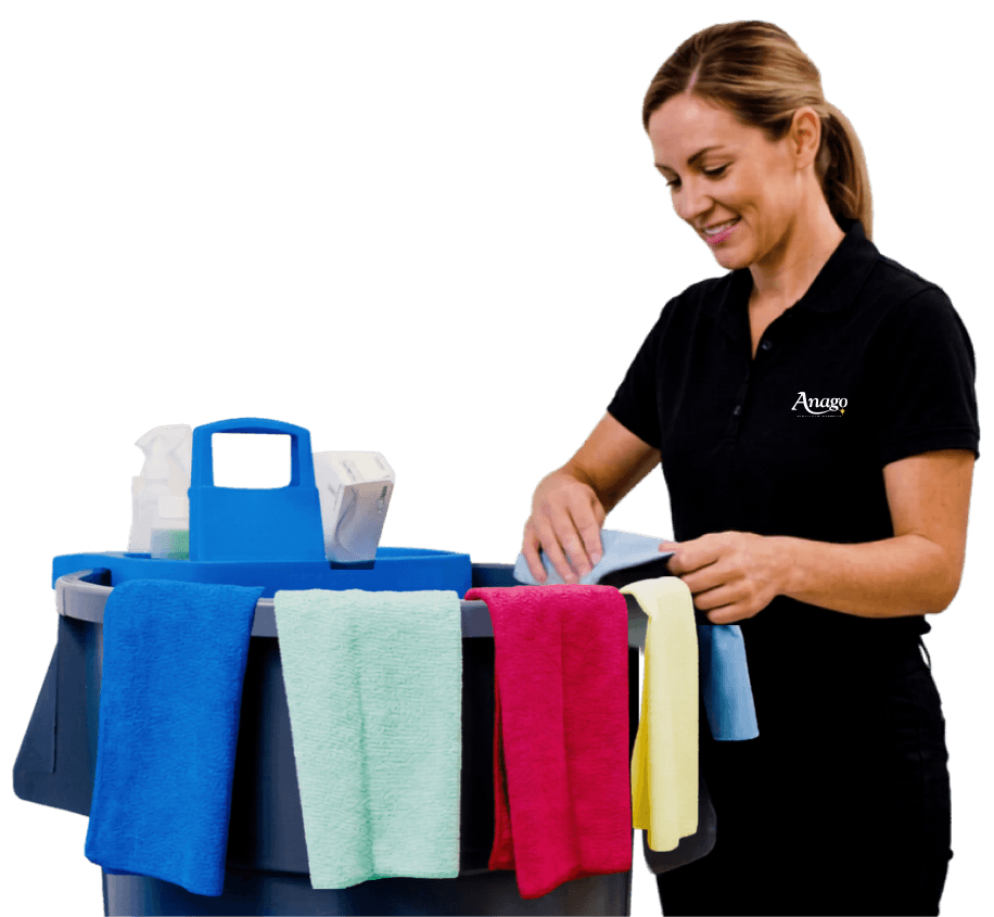 Smiling Anago cleaning professional with a stocked cleaning cart